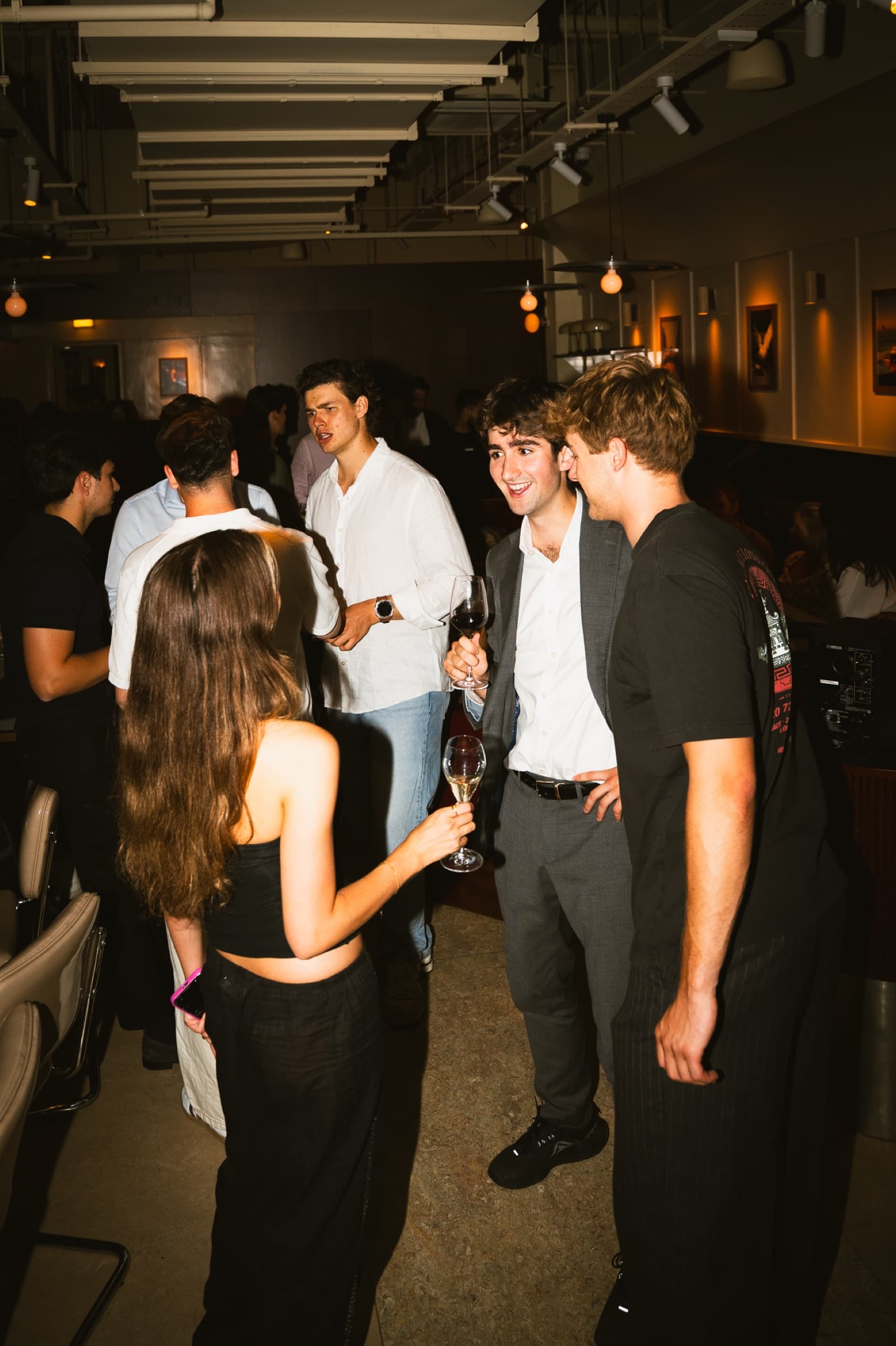Guests chatting over wine at a Clarity event